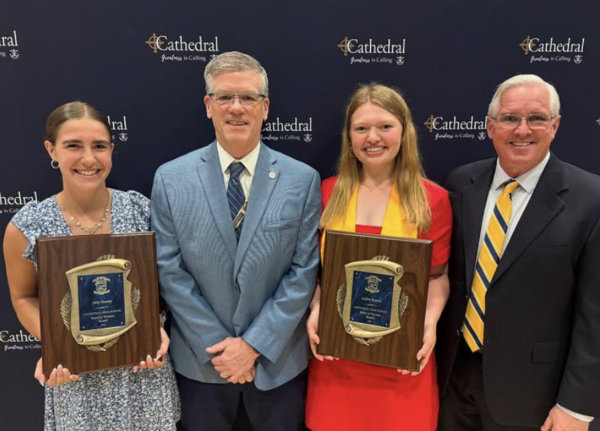 Sophia Beeson and Abby Beasely pose for a photo with President Dr. Bridges and Principal Mr. Matthews for the Board of Trustees Award. This award recognizes seniors who have shown exceptional dedication to the mission and spirit of Cathedral High School. Dr. Bridges says, “This award is given to students who demonstrate spiritual, intellectual, and social growth during the four years and have modeled the appreciation for diversity and inclusivity.”